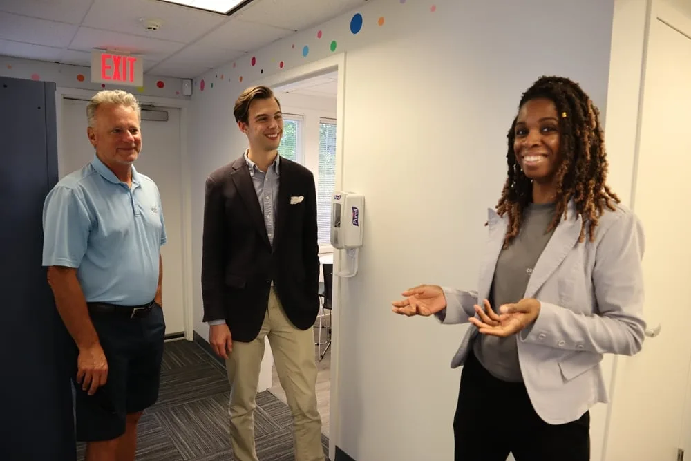 Founder Alisha Simpson-Watt speaking with visitors at Collaborative ABA Services