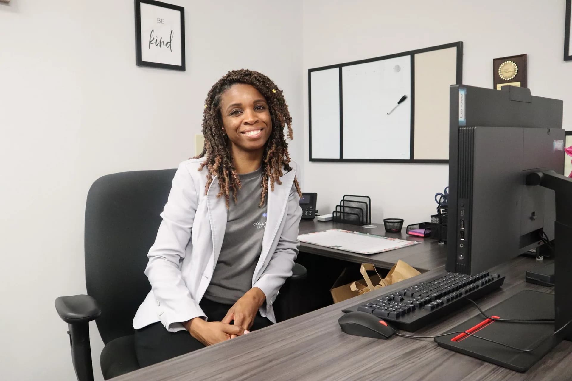 Alisha Simpson-Watt, Executive Clinical Director and Founder of Collaborative ABA Services, LLC, seated at her desk