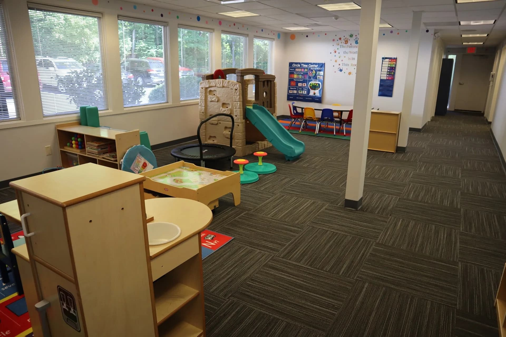 Collaborative ABA Services play and learning area with sensory tools, slide, Circle Time Center, and classroom furniture