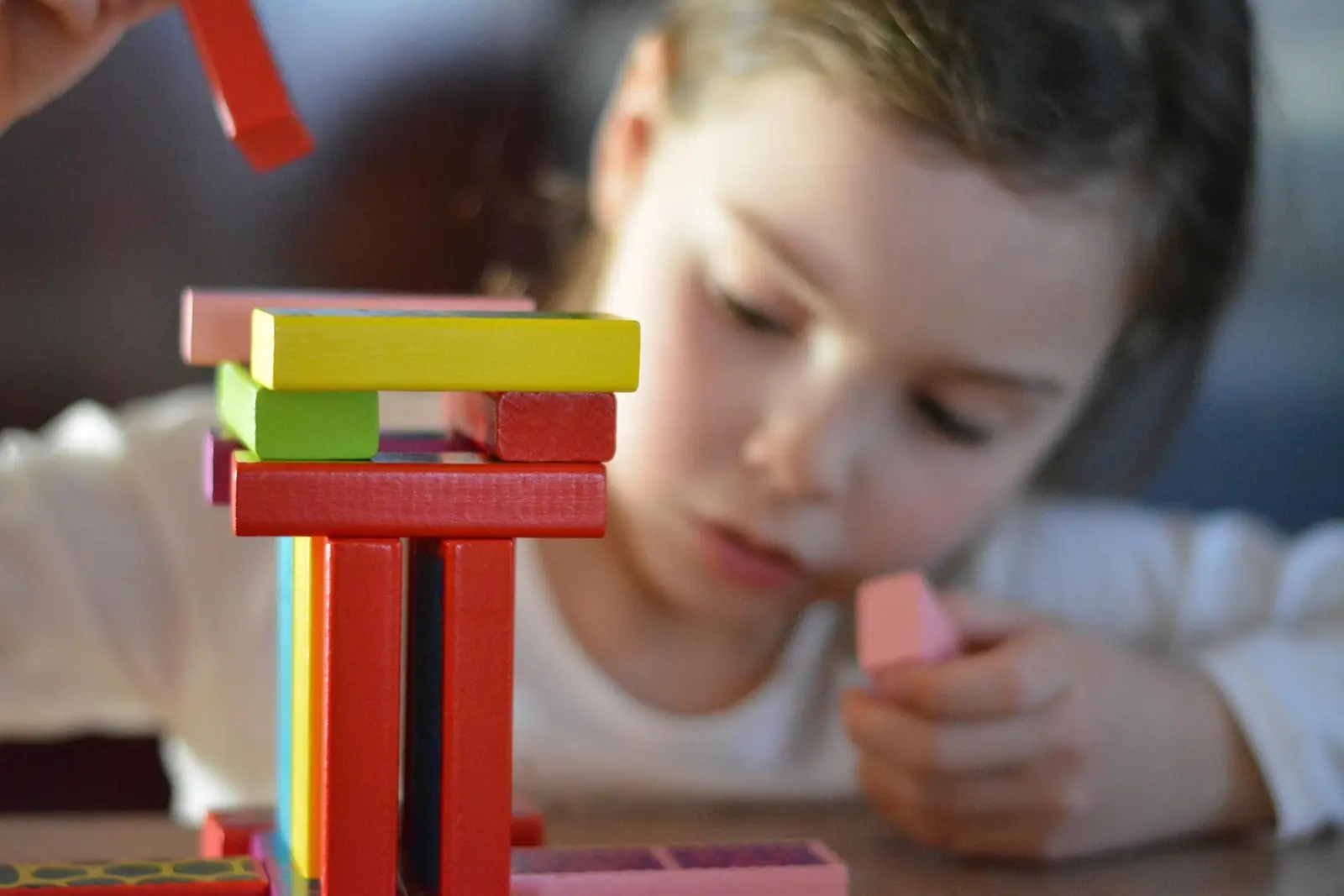 Child building with colored blocks