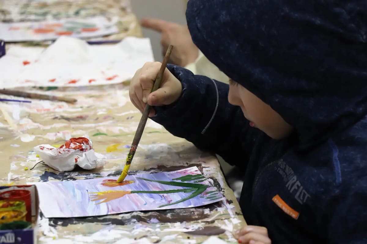 Child painting at an art table